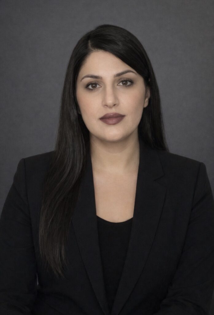Headshot of Adaxa Broker, Donna Alawadi, wearing dark suit and top